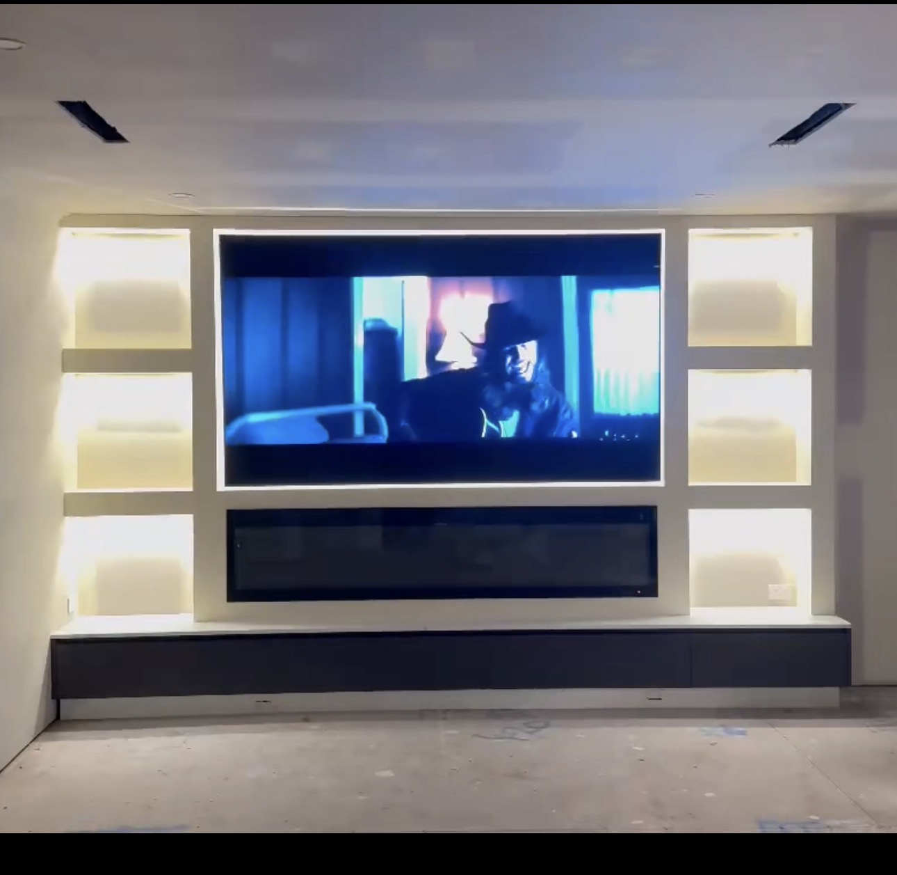 Woden media wall with LED strip lighting, downlights and power points installed by MTK Electrics & Air