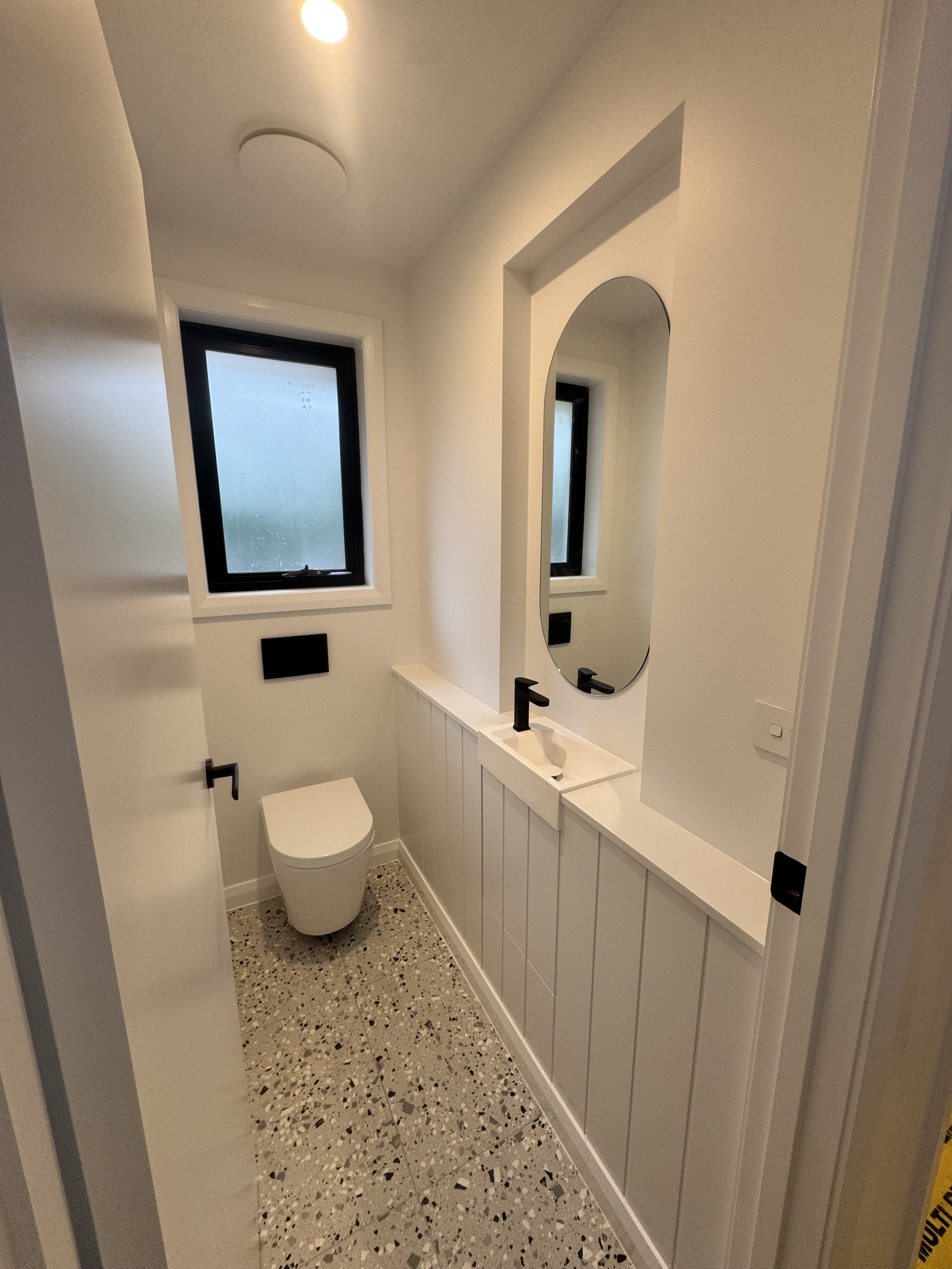 Completed bathroom renovation with backlit mirror and downlights wired by MTK Electrics & Air in Canberra