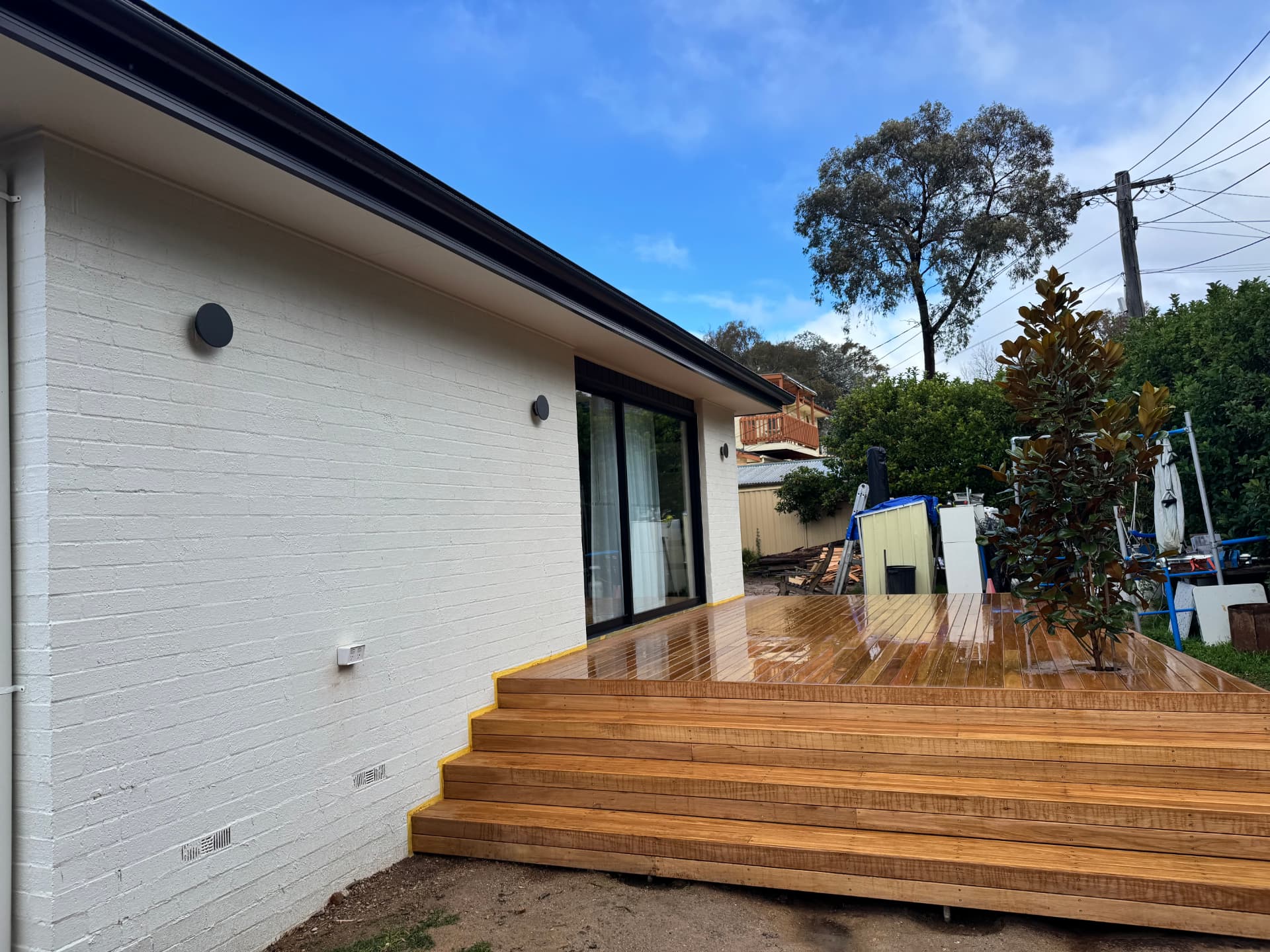 Outdoor wall lights and power point installed beside a new deck by MTK Electrics & Air
