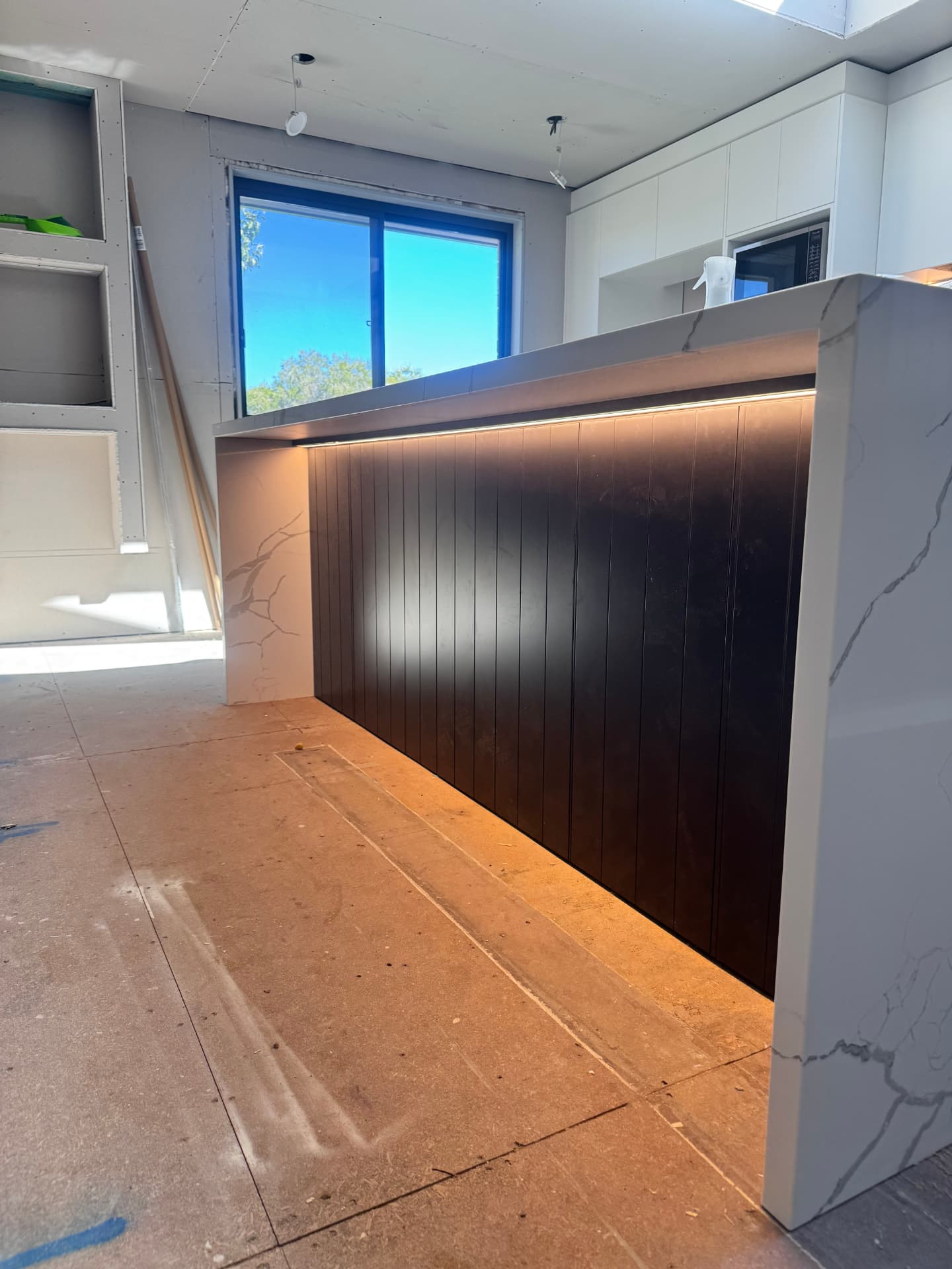 Home renovation kitchen island with LED strip lighting and stone benchtop wired by MTK Electrics & Air in Canberra